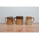 Three 19th century stoneware salt-glazed triple handled tankards, depicting hunting scenes, one with