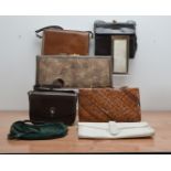 A collection of ladies handbags and clutches, including a leather Balenciaga bag, a snake skin