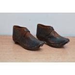 A pair of Victorian child's leather shoes, with wood and metal soles, 14cm in length both worn AF (