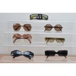 A collection of designer sun glasses, comprising Versace, two by Chloe, Dior, Armani, Marc Jacobs