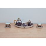 A crown porcelain Imari pattern miniature tea set for two, comprising two cups and saucers, a teapot