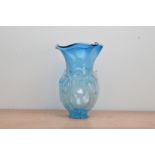 A large blue studio glass vase, globular body, with crimped rim, raised frosted decoration of