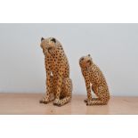 Two African hand carved and painted figurines of Leopards, of differing sizes, 26cm and 18cm H (2)