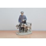A Royal Copenhagen porcelain figural group, depicting a man leading two cows, marked to the base