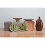 A collection of studio pottery, comprising two green glazed earthenware saucers with brown slip