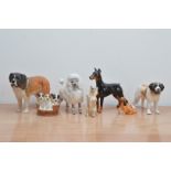 A collection of ceramic dog figurines, comprising five Royal Doulton dogs, one Beswick and
