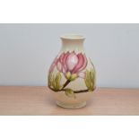 A Moorcroft pottery vase, magnolia pattern 18.5cm high