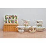 Six Royal Albert bone china cups and saucers, together with ceramic place holders, floral design (