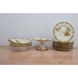 A Royal Crown Derby dessert set, comprising a cake stand, 12 plates, and four shaped serving