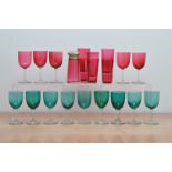 A collection of coloured glass, comprising five cranberry wine glasses, six large shot glasses and a