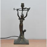 An art deco style bronzed metal lamp shade, depicting a lady as the column, with three butterflies