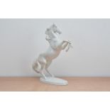 An early 20th century Austrian porcelain blanc de chine figurine of a Horse, marked to the base,