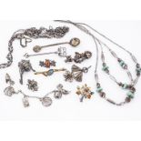 A collection of silver and white metal jewellery, including a silver butterfly brooch, a filigree