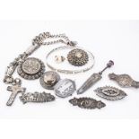 A collection of silver jewels, including a religious bangle, eight Victorian and Edwardian brooches,