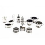 A small group of silver cruet items and three napkin rings, including a pair of damaged peppers, a