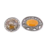 A continental amber and white metal oval brooch, pebble amber with bead and pierced design, 5.5 cm