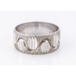 An 18ct white gold wedding band, textured finish, with a wavy design, 8.7mm wide, ring size R, 7g