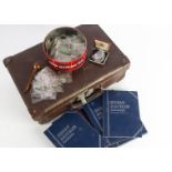 A collection of French and British and other coins, presented in a small card suitcase, most in