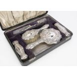 An Edwardian silver dressing table set by William Hutton & Sons, in a fitted black leatherette case,