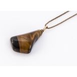 A tigers eye pendant on a 9ct gold chain, marked 9ct, 30 cm together