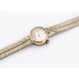 A 9ct gold ladies wrist watch, circa 1970, with champagne dial, baton numerals, strap (af) 21g