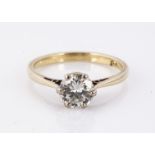 An 18ct marked diamond solitaire, the brilliant cut in six clawed white metal setting, on a yellow