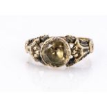 A 19th century topaz posy ring, the circular mixed cut in rubbed over settings, with pierced fleur
