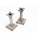 A pair of late Victorian silver filled short Corinthian column candlesticks from William Hutton &