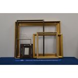 A collection of frames, including gilt style, wooden and Hogarth style examples, the largest 70cm