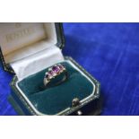 A Chester 9ct gold early 20th century garnet and seed pearl ring, oval mixed graduated cut stones,