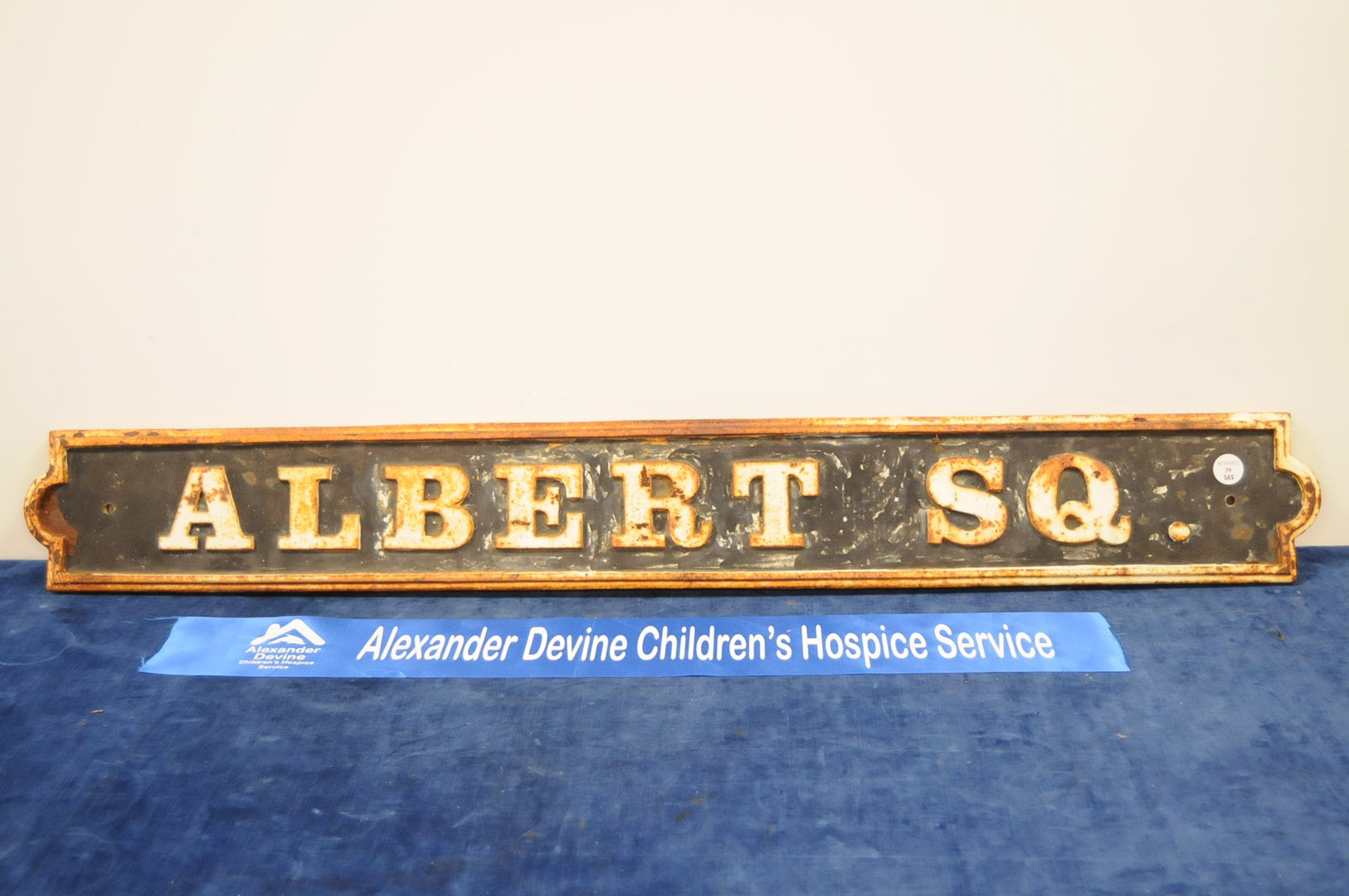 A cast metal Albert Square sign, 109cm wide IMPORTANT! REGARDING CONDITION REPORTS: Please note this