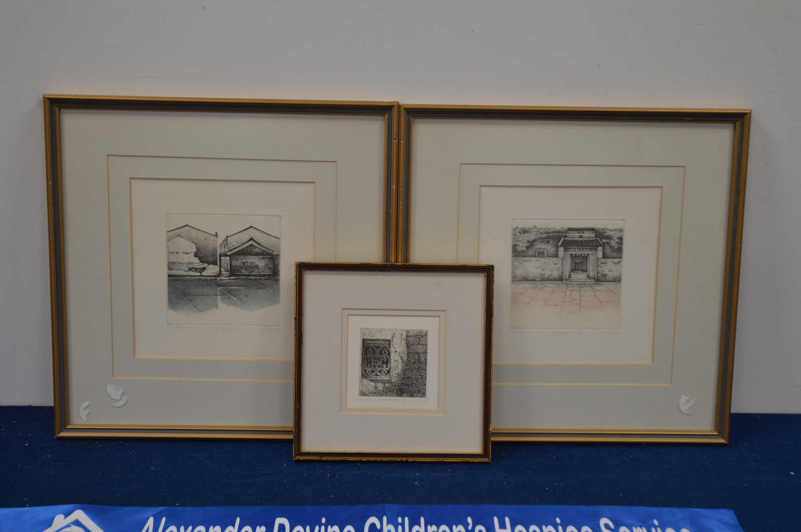 Three limited edition prints of buildings, two of cottages, the other a window, the largest pair