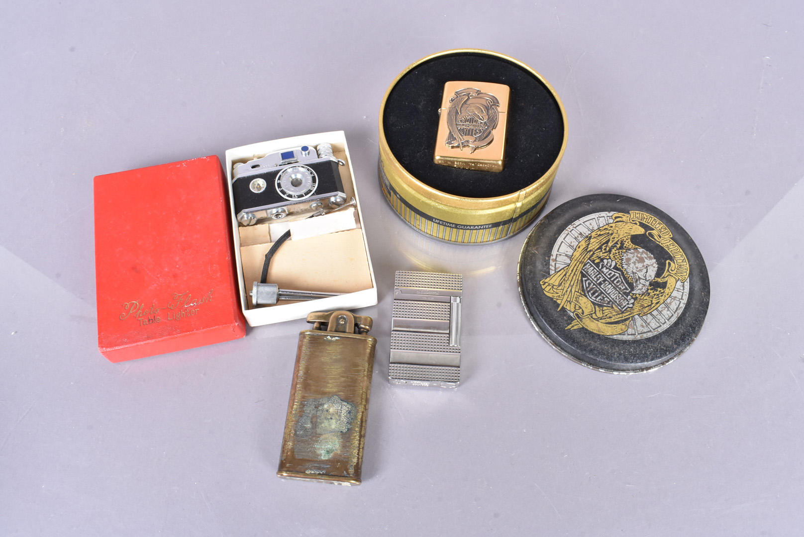 A 1995 brass Harley Davidson Zippo lighter, in retailer's case, together with an S.T Dupont, an