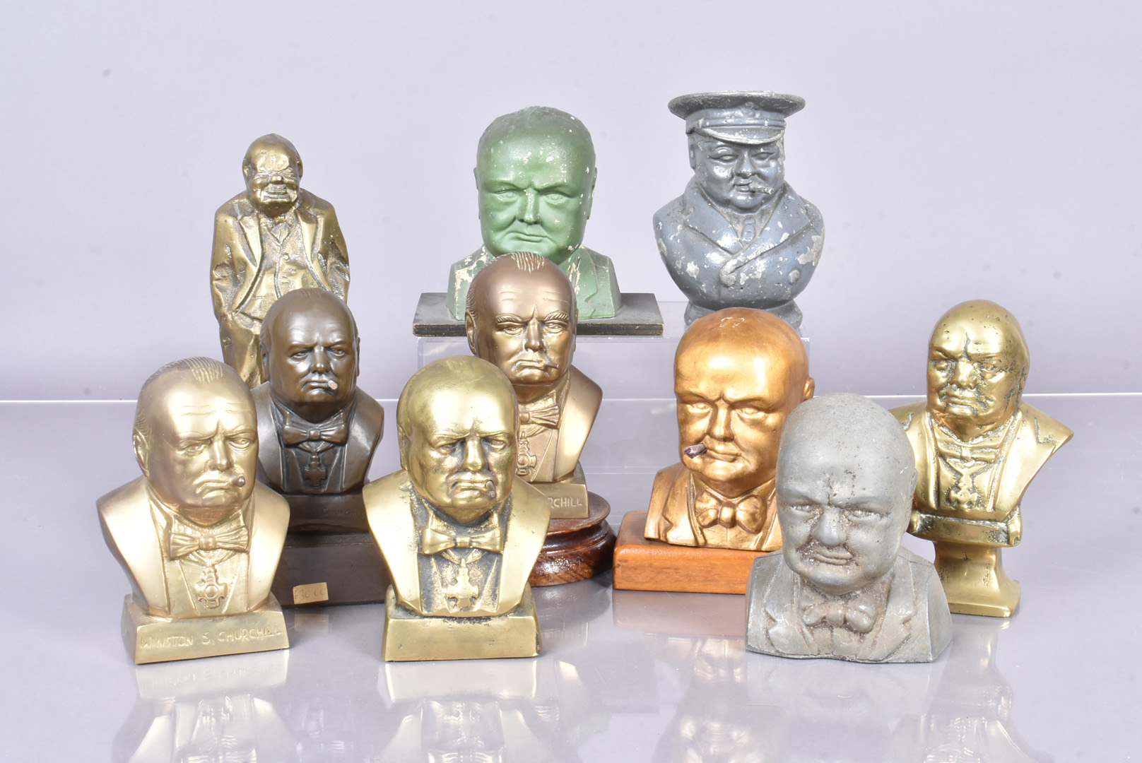 An assortment of metal Churchill busts, including an example by R A Pickering, plus a 1940s money