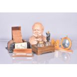 A carved wooden Winston Churchill ashtray music box, with Swiss Reuge movement, together with a