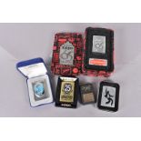 A group of five Zippo lighters, to include the 65th Anniversary, the Biohazard 25th Anniversary,