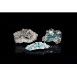 Dioptase/Diopside on quarts, three small pieces of quartz, with pieces of the green mineral