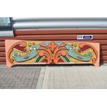 A vintage Fairground ride panel, with vibrant colours with scroll design to background, approx.