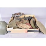 A collection of War period and later items, including a helmet, gas mask, caps, water bottle and