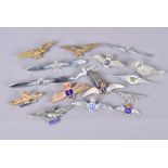 A collection of RAF wing brooches, comprising silver and base metal examples, different ages and