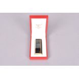 A Must de Cartier Plaque de Laque Noire pocket lighter, with black laquer panel design, stamped '