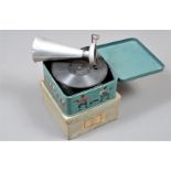 A child's tinplate gramophone, Bing Pigmyphone, in green case with transfers of musicians and