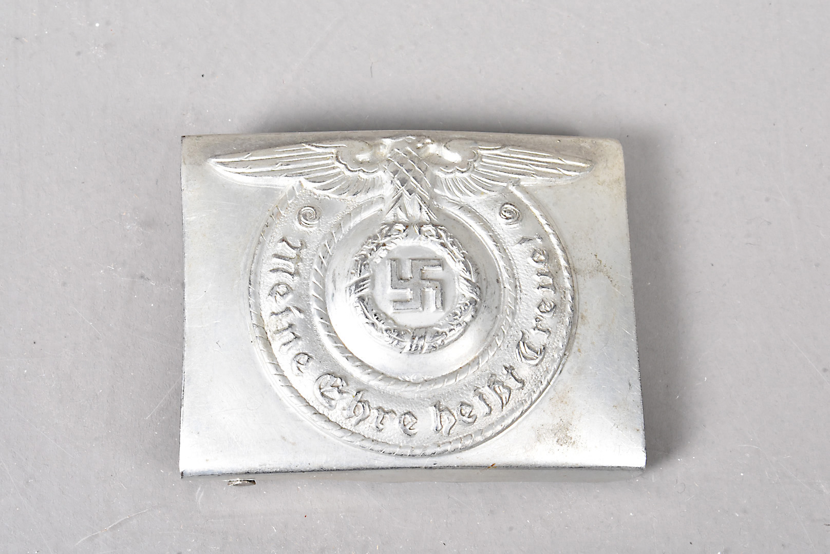 A WWII German SS Belt Buckle, the white metal buckle with eagle and swastika to the front, stamped