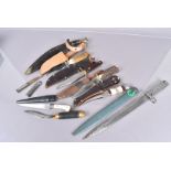 An assortment of various knives, to include Bowie style knives, hunting knives, a bayonet, a kukri