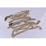 An assortment of helmet chin straps, white and yellow gilt metal chains with leather backing,