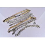 An assortment of helmet chin straps, white and yellow gilt metal chains with leather backing,