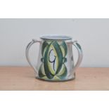 An Aldermaston pottery tyg, c. 1990's, triple handled, with 'G' decoration, marked to the