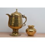 A late 19th century brass samovar, with double hinged lid and pierced bass, the spout cover missing,