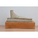 Mo Jupp (British 1938-2018), a stoneware sculpture of a foot/shoe, with a grey slip, on a