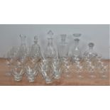 A large collection of glassware, comprising six decanters of differing sizes and styles, eleven wine